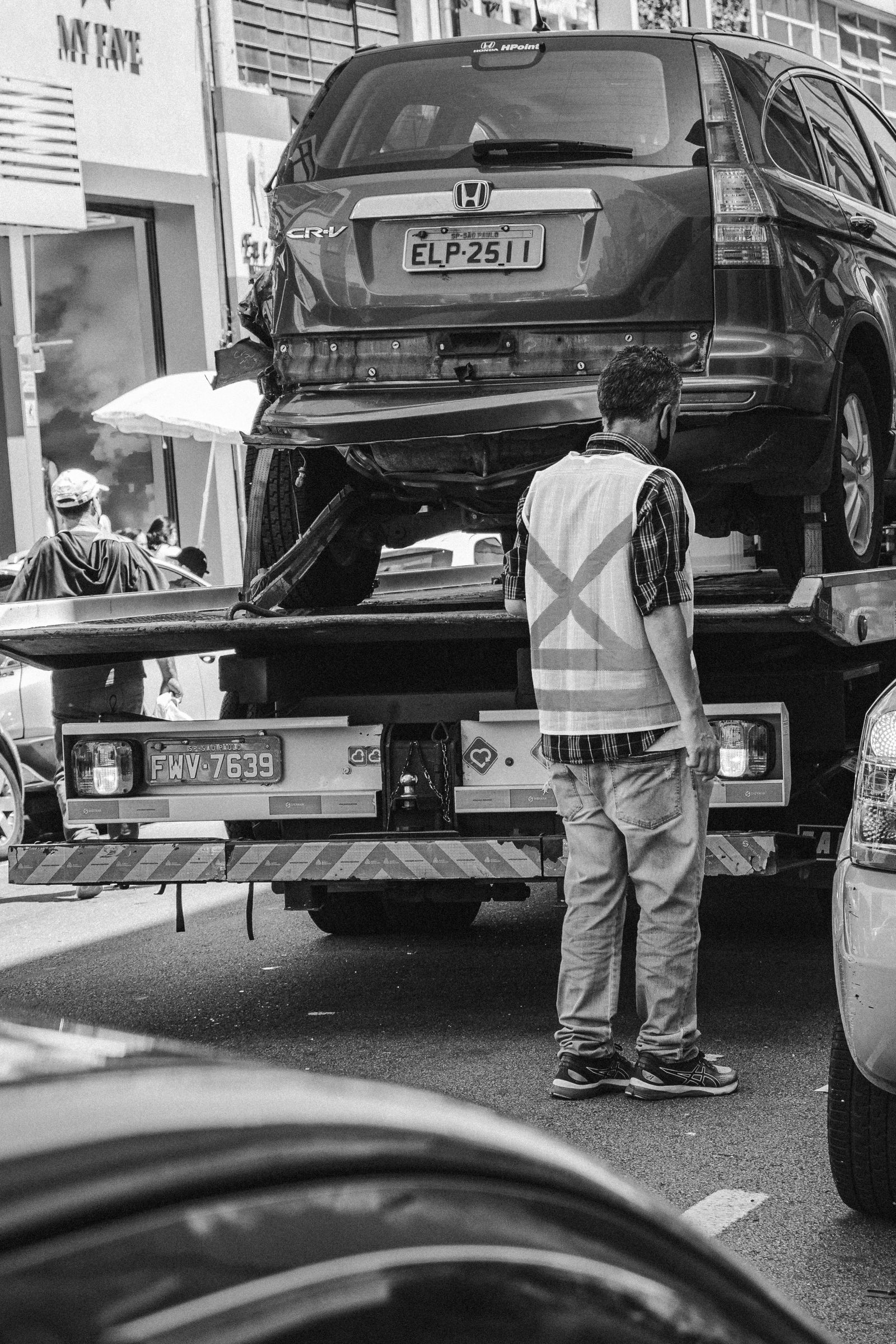 Tow truck loading a vehicle on a city street